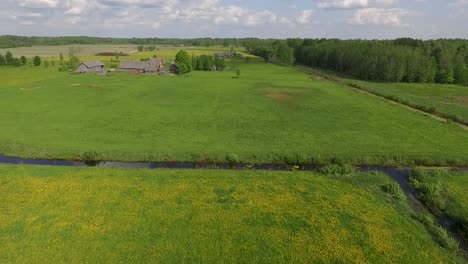 Country-side-panoramic-landscape-in-summer-time-from-above-and-ground-with-hay-rolls-and-roads