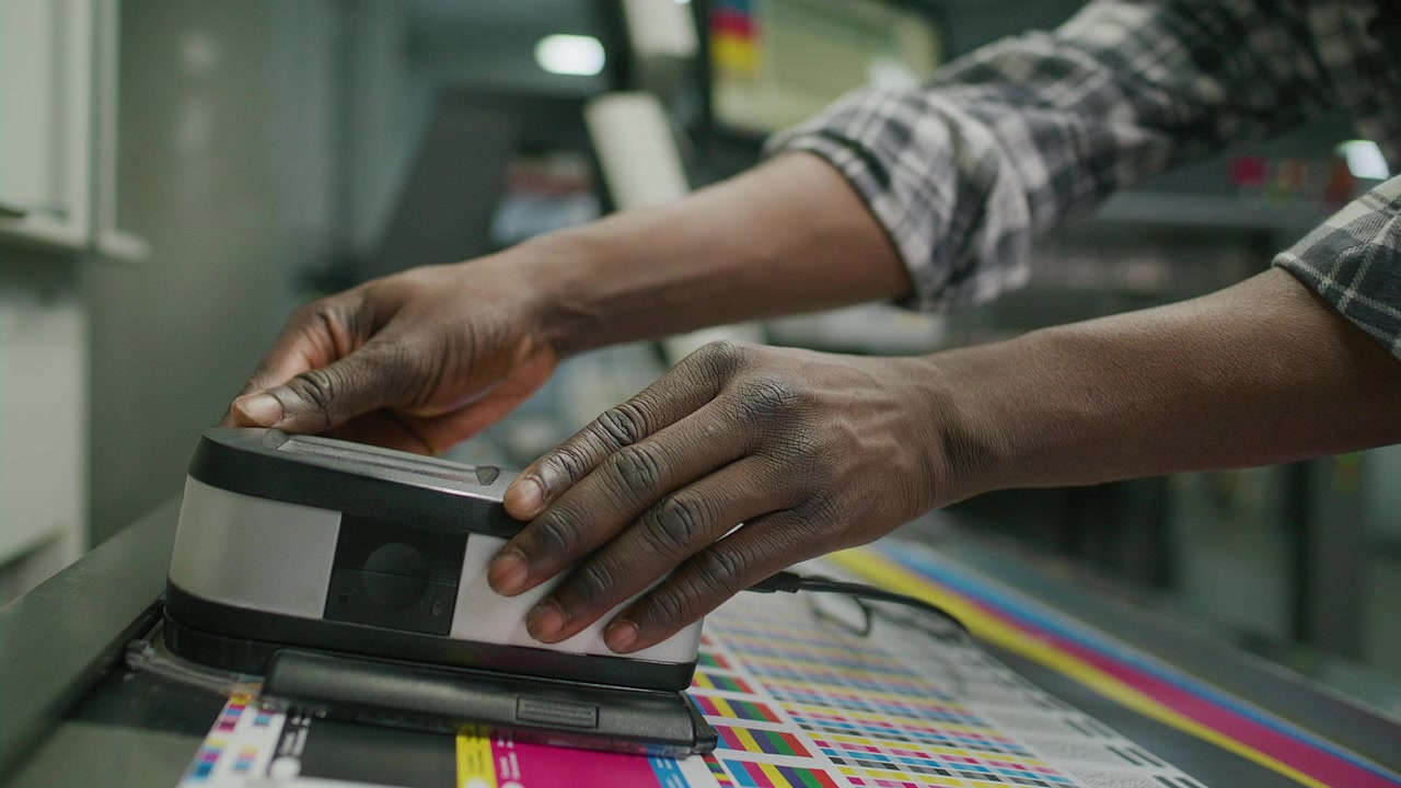 Printing House Technician Measuring Color Calibration with Spectrophotometer