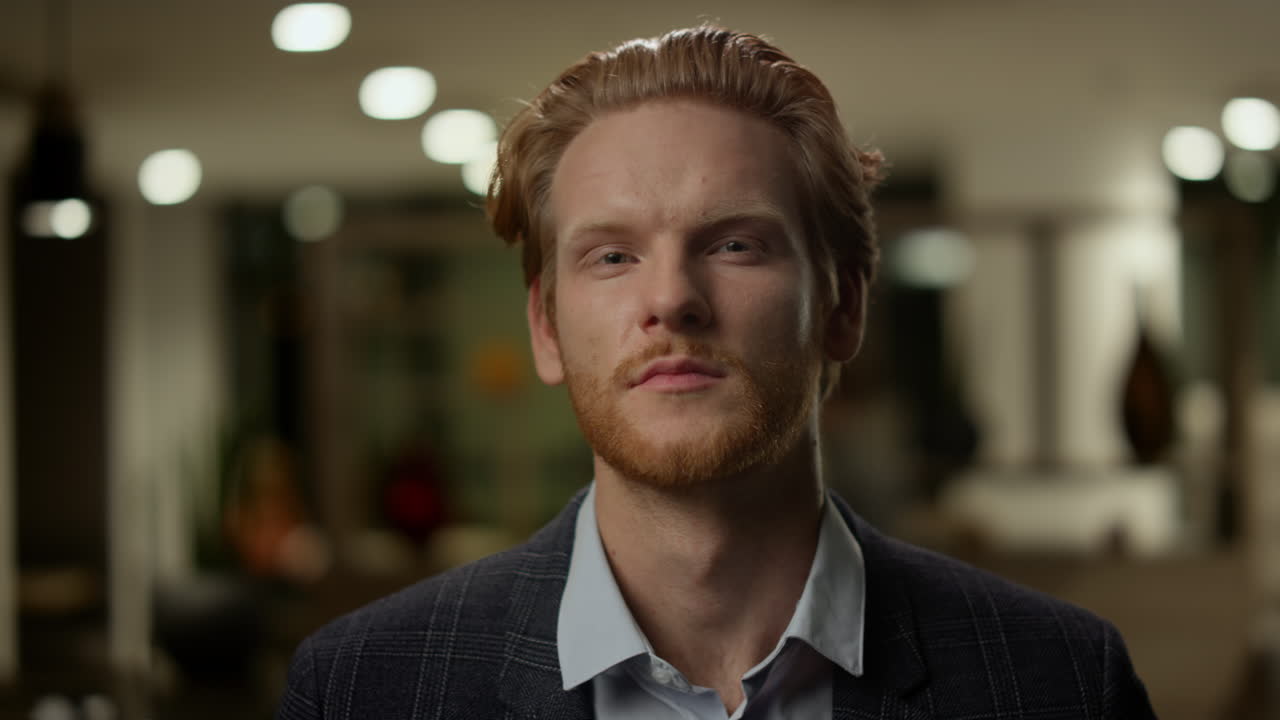 사무실 로비에 서 있는 사업가. 미소 짓는 남성 노동자가 카메라에 포즈를 취하고 있다