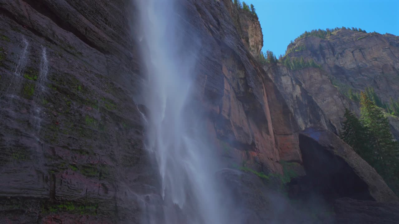 Telluride Bridal Veil Falls Waterfall Box canyon view Colorado landscape pan down slowly mist spray close up Box Canyon cliffside 4wd hiking Black Bear Pass Board sunny blue sky shade