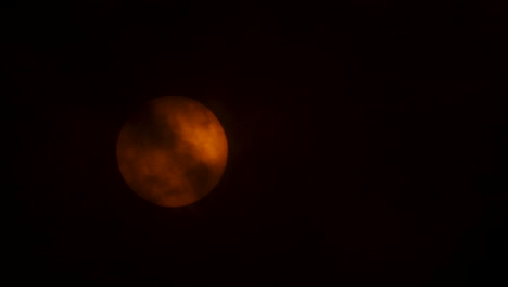 close up of the sun being revealed by clouds on a cloudy day