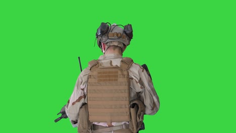 ranger in combat uniform walking on a green screen, chroma key