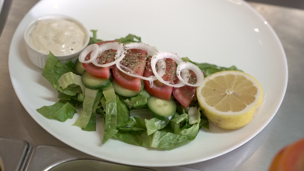 Fresh and vibrant salad creation featuring cucumbers, tomatoes, and zesty lemon served on a sunny afternoon