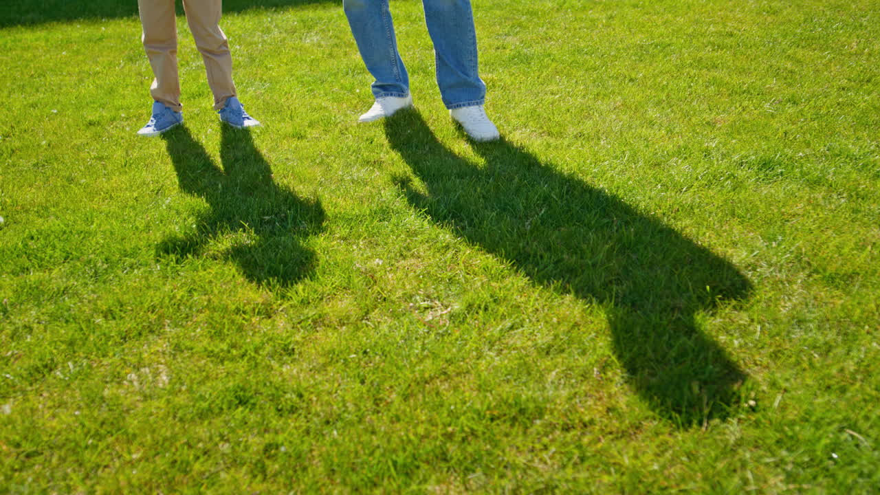 Father kid shadows grass closeup. Unrecognizable man communicating with child