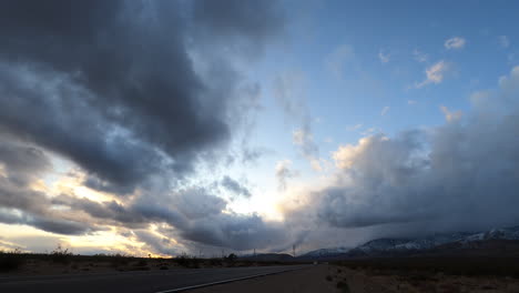 Thick-storm-clouds-over-busy-highway-in-desert-affecting-visibility,-Timelapse