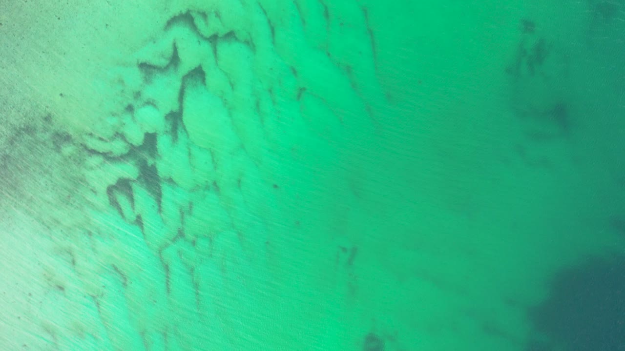 the cinematic beauty of Lofoten Islands with this 4K drone footage. Capture the essence of Norway's Arctic landscapes through dramatic aerial views. the green ocean and the magical colour.