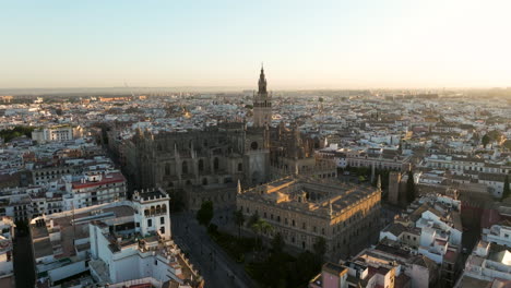 Aerial-View-Of-Historic-Cathedral-of-Saint-Mary-of-the-See,-Seville-Cathedral-At-Sunrise-In-Seville,-Andalusia,-Spain