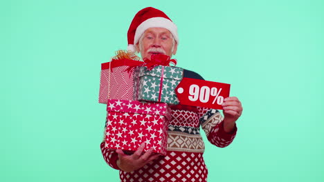 Senior-man-in-Christmas-sweater-showing-gift-box-and-90-Percent-discount-inscriptions-banner-text