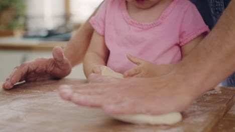 handheld view of little girl making cookie with daddy