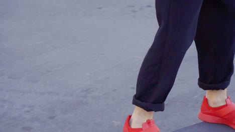 Young-man-in-red-sneakers-skating-in-the-street