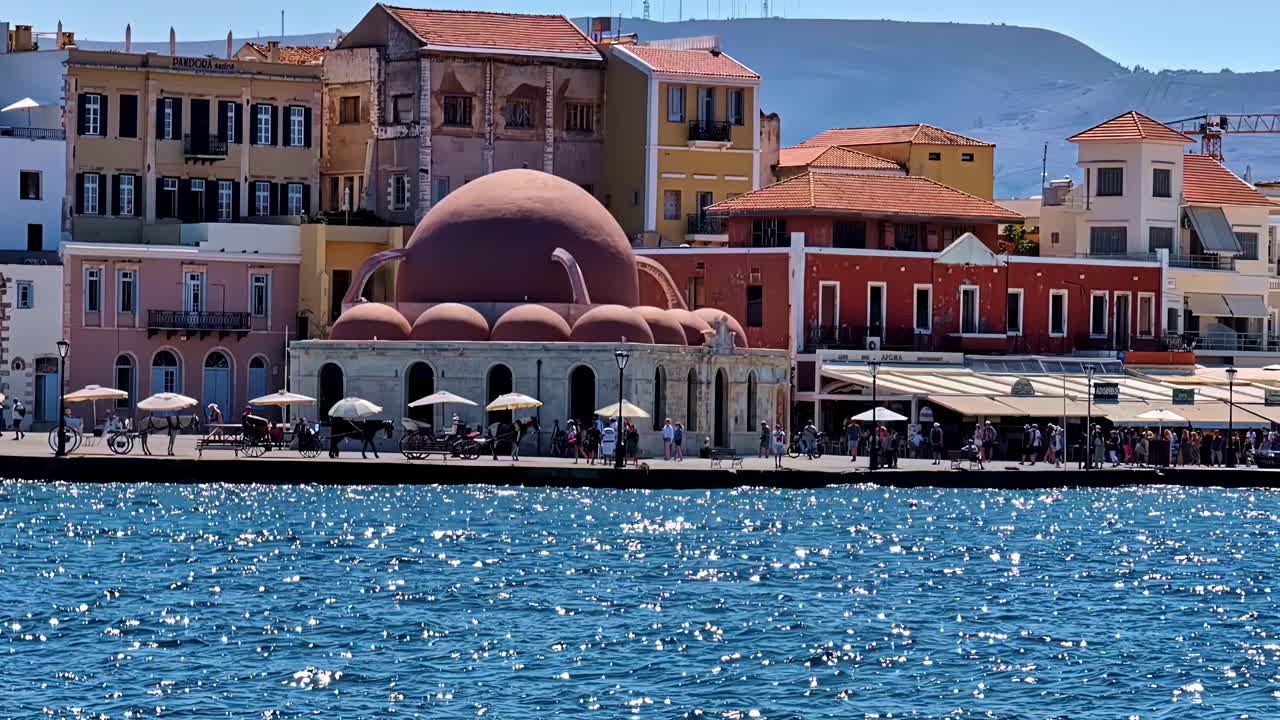 Colorful harbor view of Chania. Domed Kucuk Hasan Mosque is a local highlight