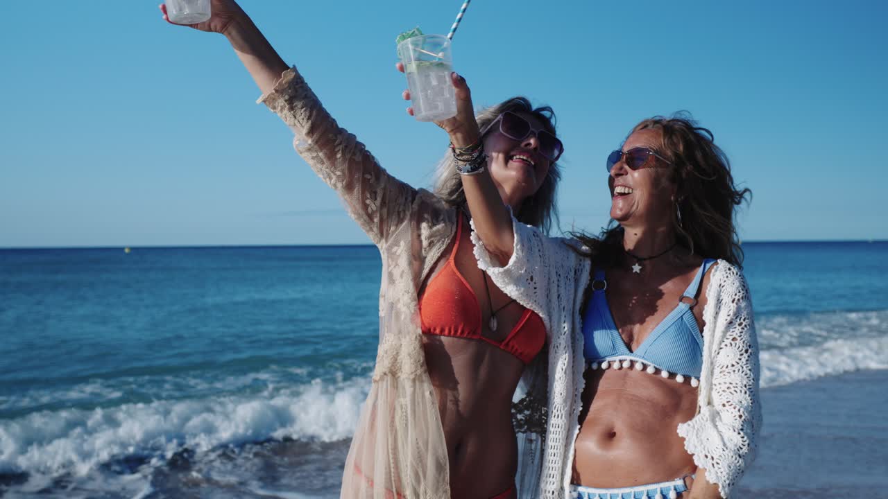 Two Women Enjoying Cocktails on the Beach