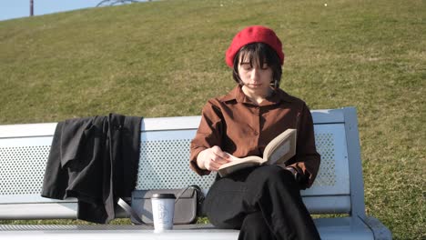 Reading-Novel-On-Bench