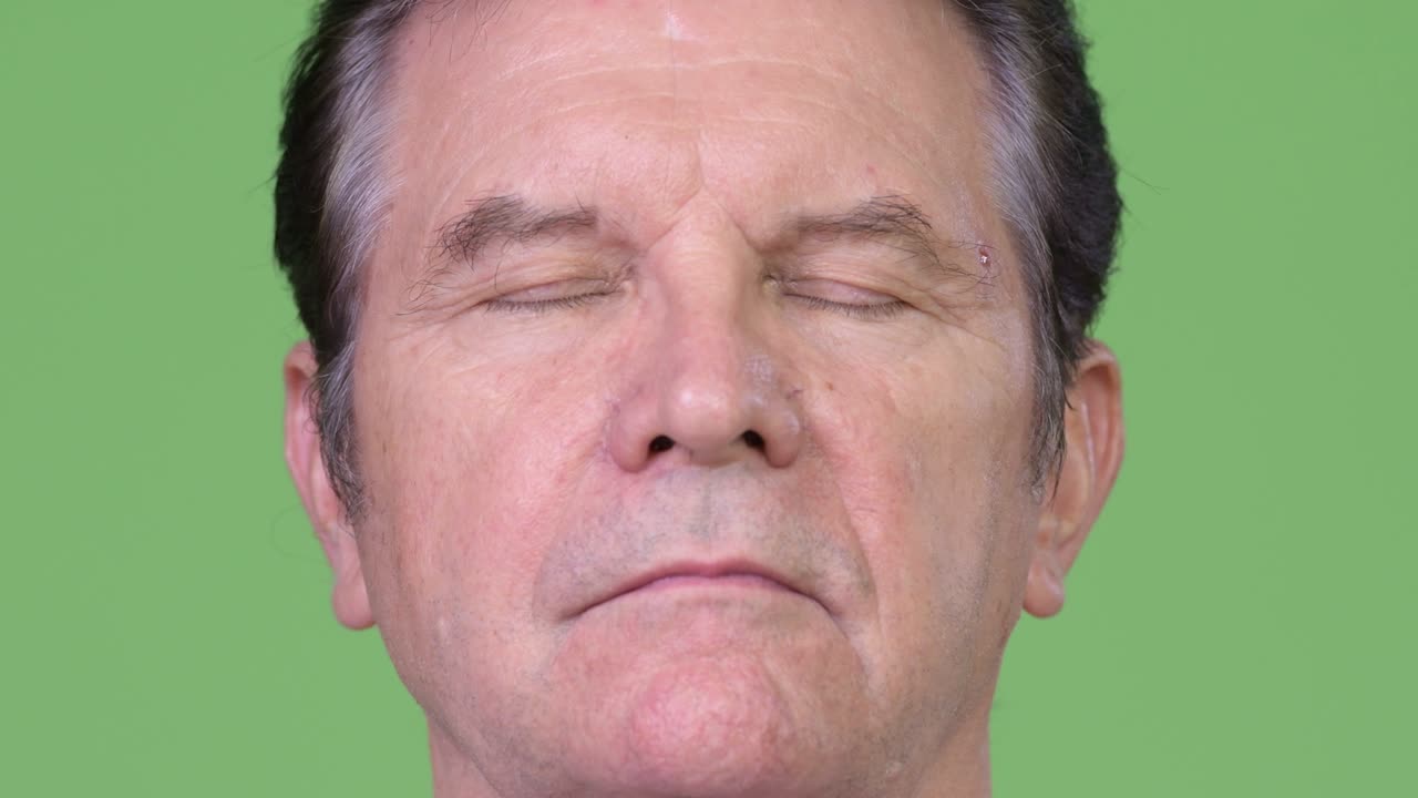 Senior handsome man relaxing with eyes closed