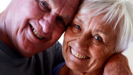 happy senior couple romancing in bedroom