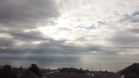 timelapse: leman lake, cloudy day and a few sun rays, french mountains on the opposite side of the alpine lake
