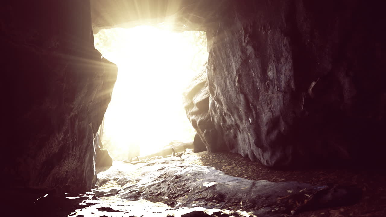 Light spills into a cave revealing natural textures and formations