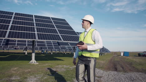 solar panel engineer inspecting a solar farm