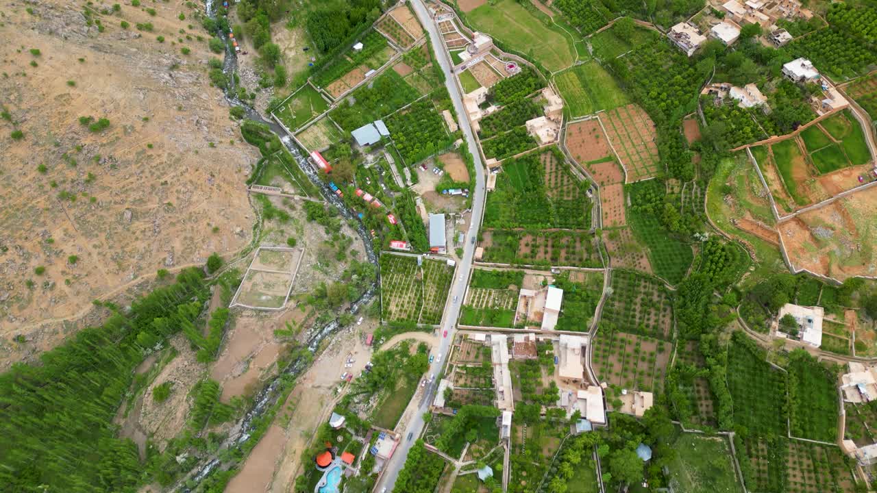 Kabul Aerial drone view of agricultural farm land in a lush, rugged mountain valley in Afghanistan