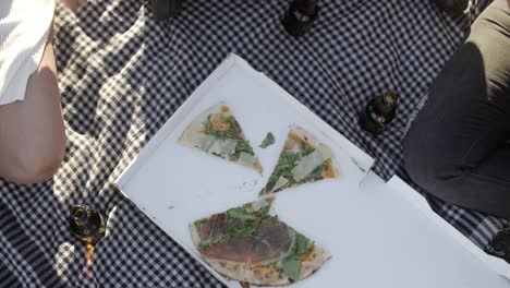 cropped shot of friends eating pizza