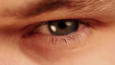 closeup view of a young man's eye keep on blinking - close up shot