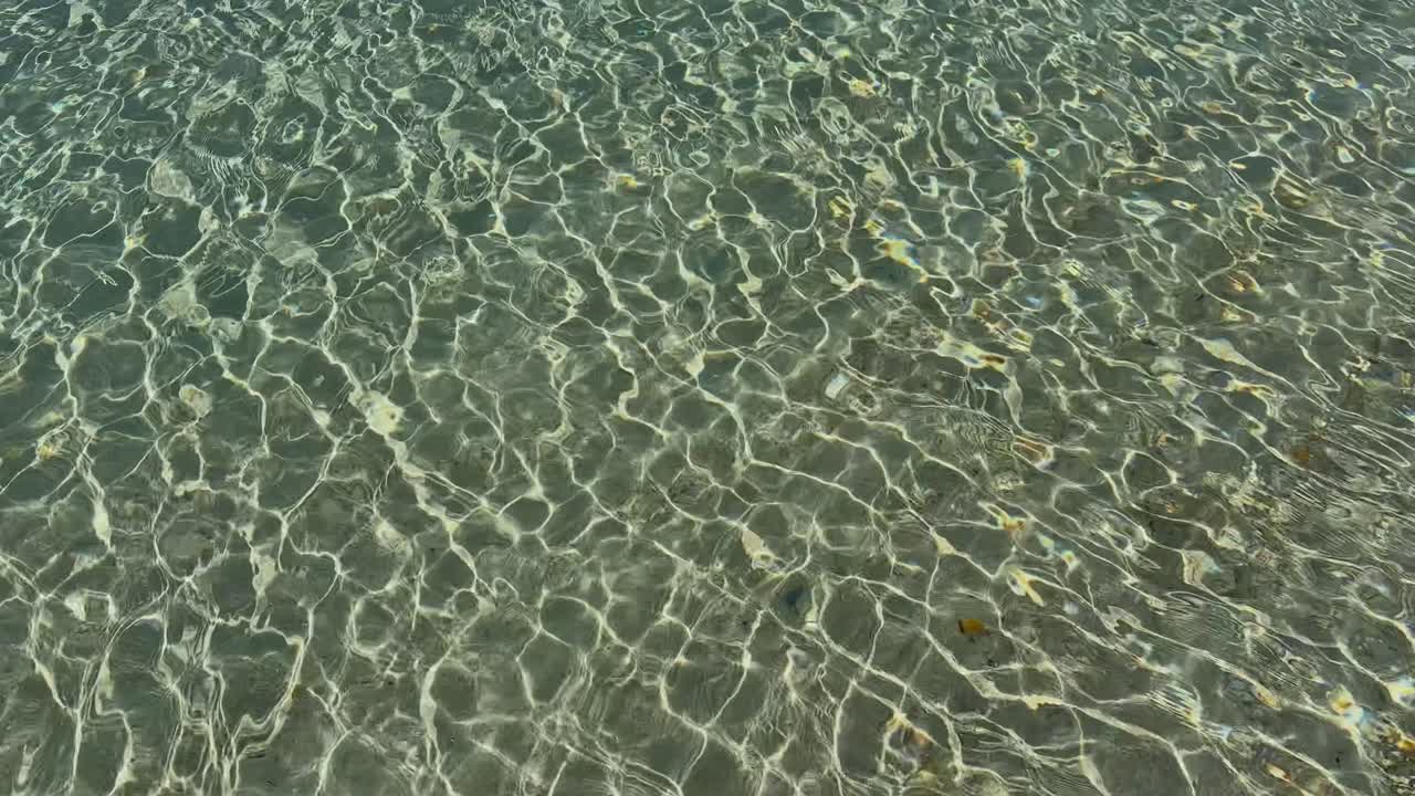 Stunning beach scene in Halkidiki, Greece, with elegant sunbeds facing the crystal-clear turquoise sea. A perfect summer escape in the heart of the Aegean.