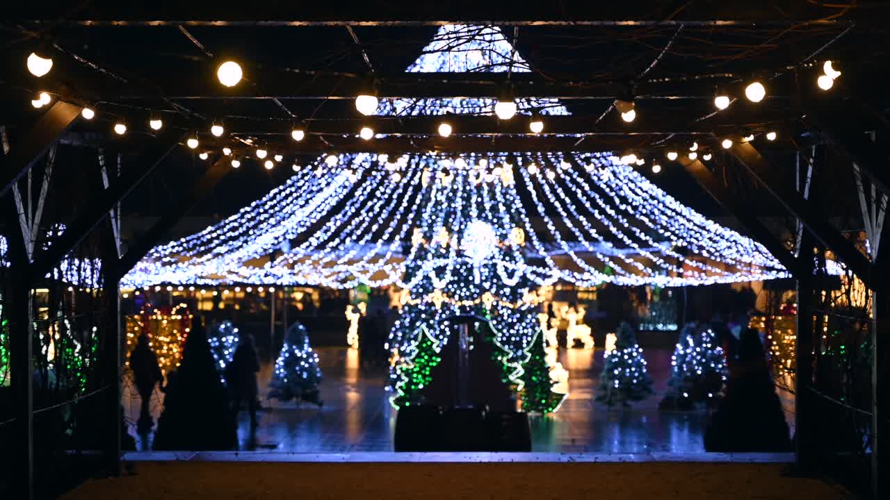 Chisinau, Moldova - December 12, 2021: People walking through the Christmas Market in the evening