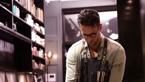 male barber working in barber shop