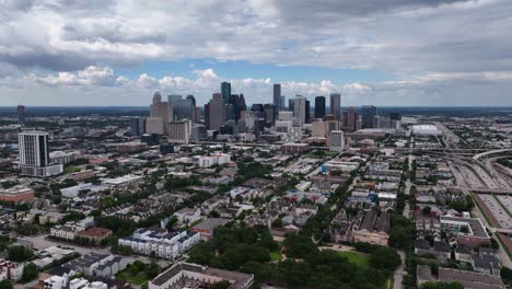 aerial view towards the houston city skyline, in cloudy texas, usa - approaching, drone shot