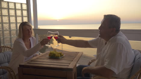 mature couple spending time on drinking wine