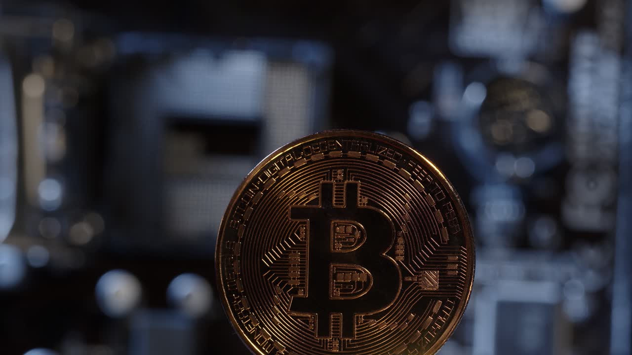 Bitcoin BTC spinning on digital technology pc motherboard background, cryptocurrency money mining
