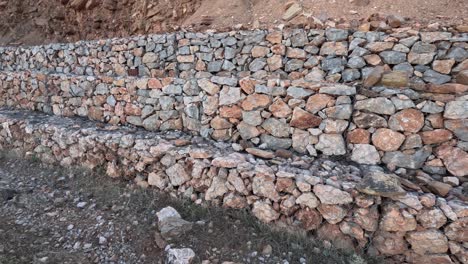 strengthening the slope with stones behind the wire