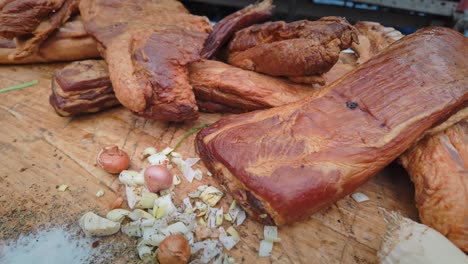 selection of cured smoked pork meats displayed on festival stall slide shot