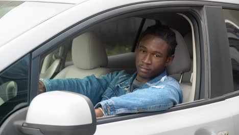 african american man sitting in his luxury car