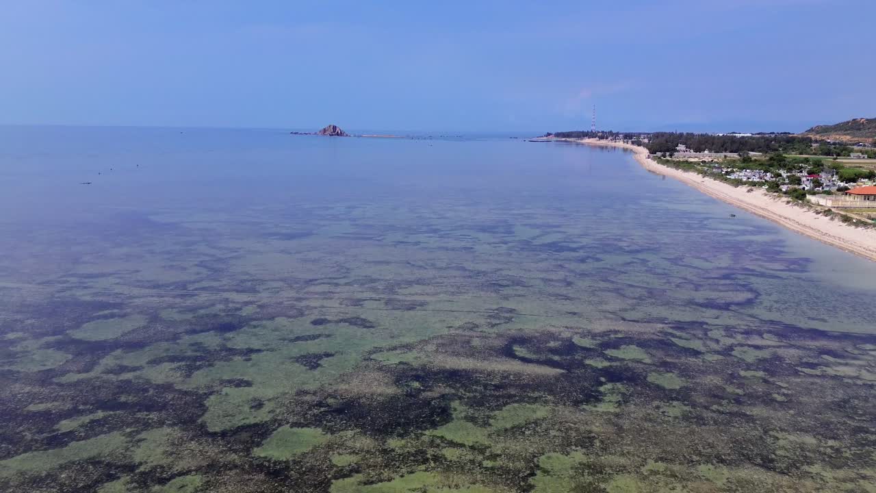 Drone aerial over My Hoa Town showing colorful rooftops and the tranquil lagoon, capturing vibrant tropical townscape in Vietnam