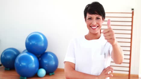 Pretty-physiotherapist-smiling-at-camera