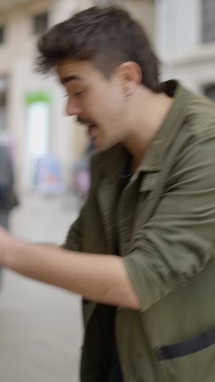 Man interacting on a city street, possibly exchanging cards