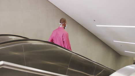 African american man on the go wearing coronavirus covid19 mask
