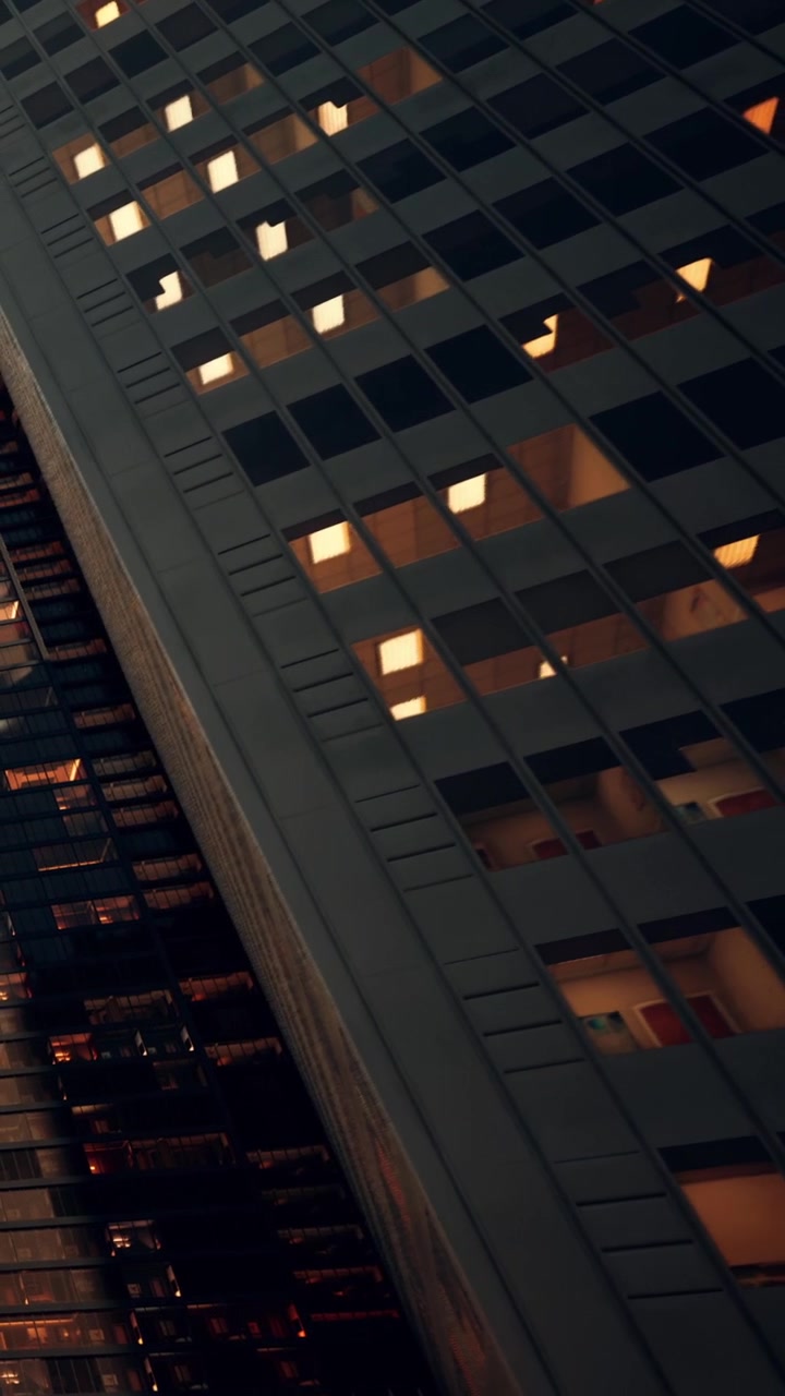 City buildings with lights on during the evening hours