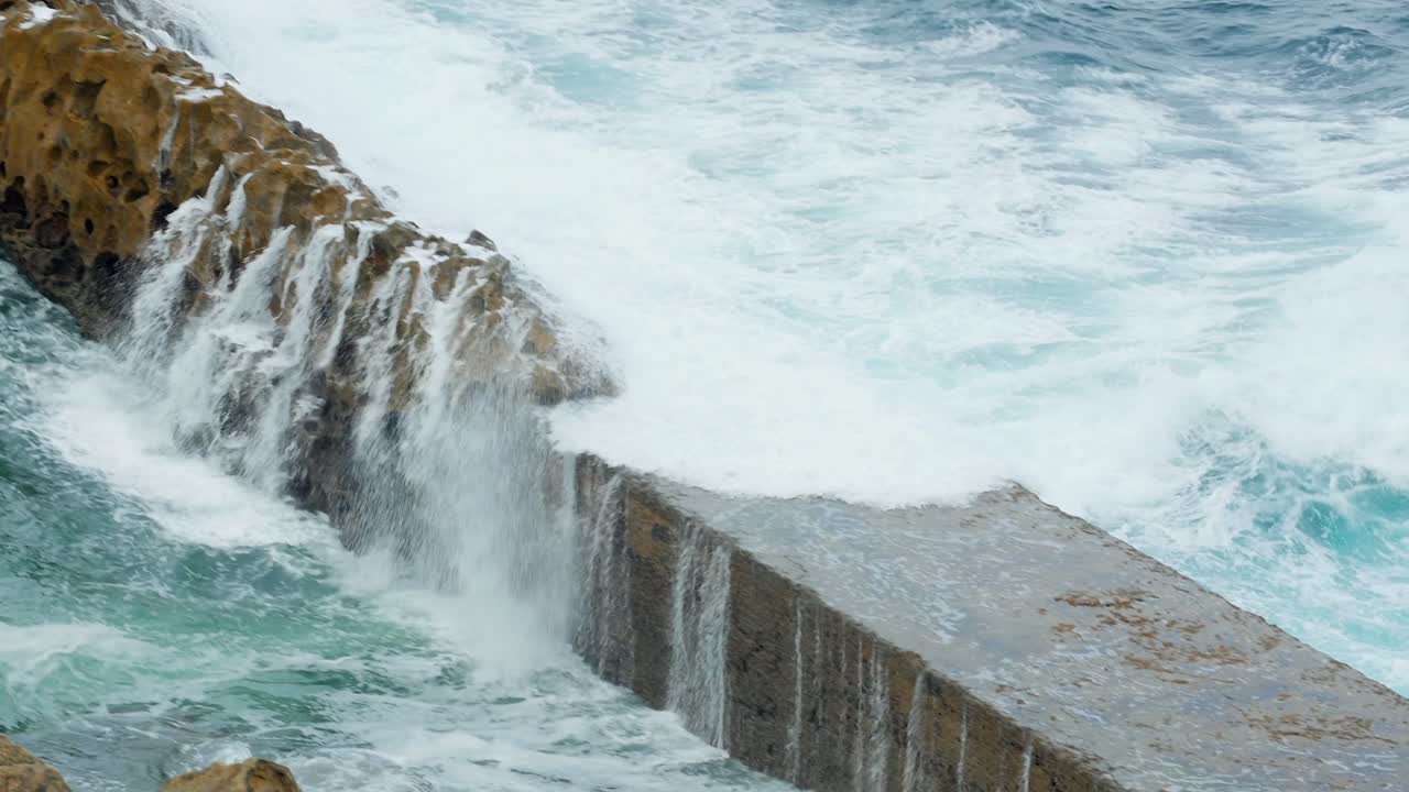 Dramatic Waves Crashing Against Lighthouse on Rocky Coast