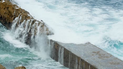dramatic waves crashing against lighthouse on rocky coast