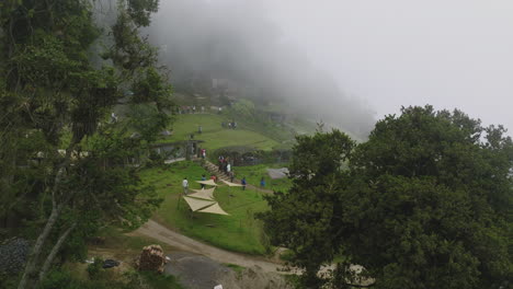 aerial footage flying through the trees in the village of hobbitenango in guatemala