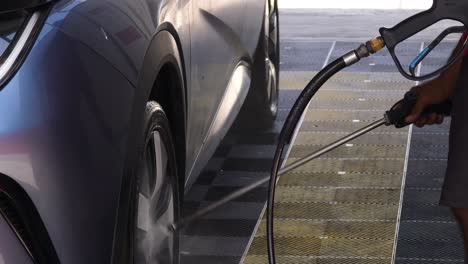 electric car being washed with high pressure washer