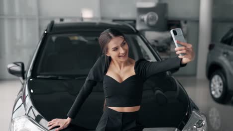 happy nice girl taking selfie on smartphone with new car