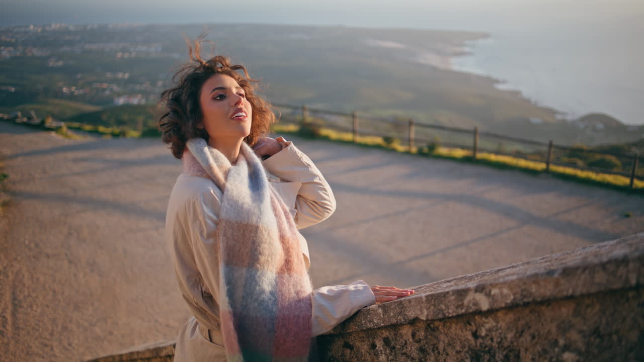 Contemplative woman relaxing vacation on scenic coast sunset. Romantic tourist