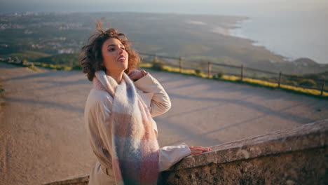 contemplative woman relaxing vacation on scenic coast sunset. romantic tourist