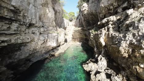 secluded cove with turquoise waters between rugged cliffs