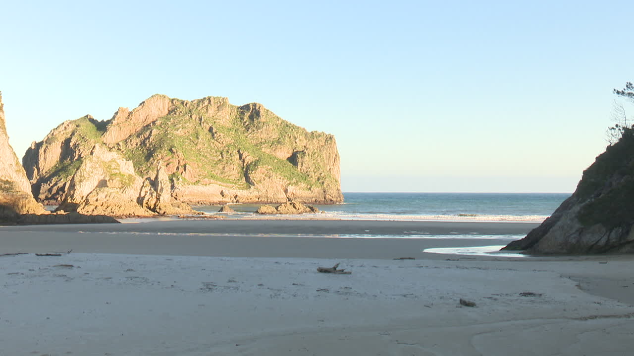 Coastal Beach Scene with Rocky Mountains