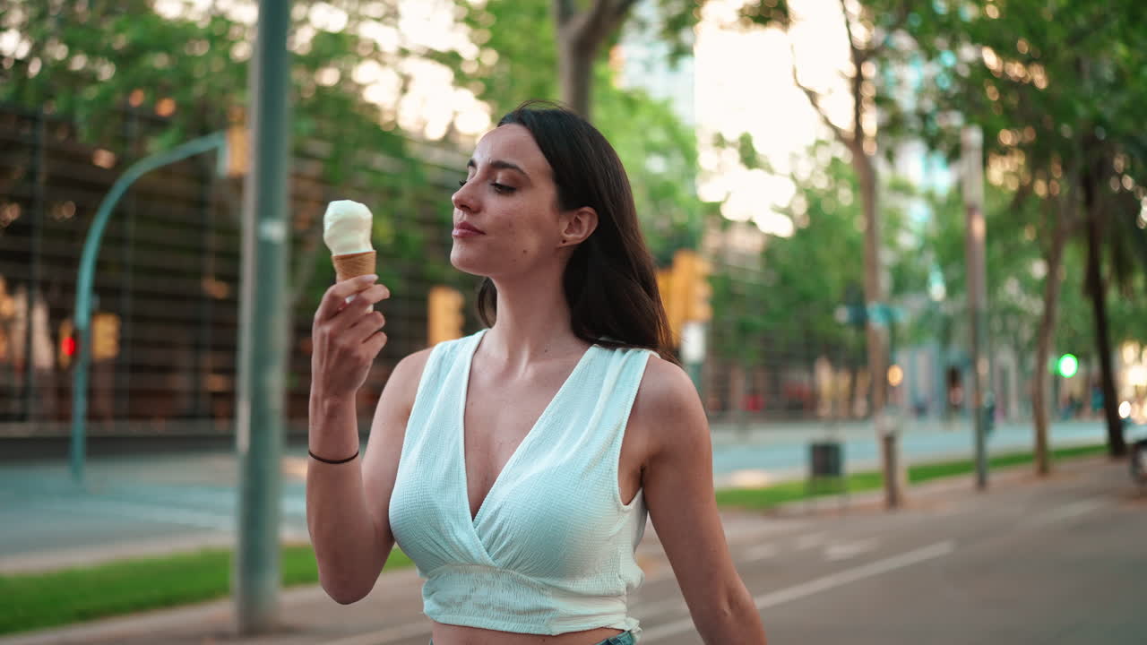 Woman eating ice cream on a city street
