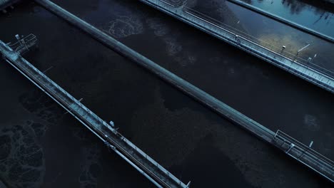 aerial view of separated sewage containers, camera moving up